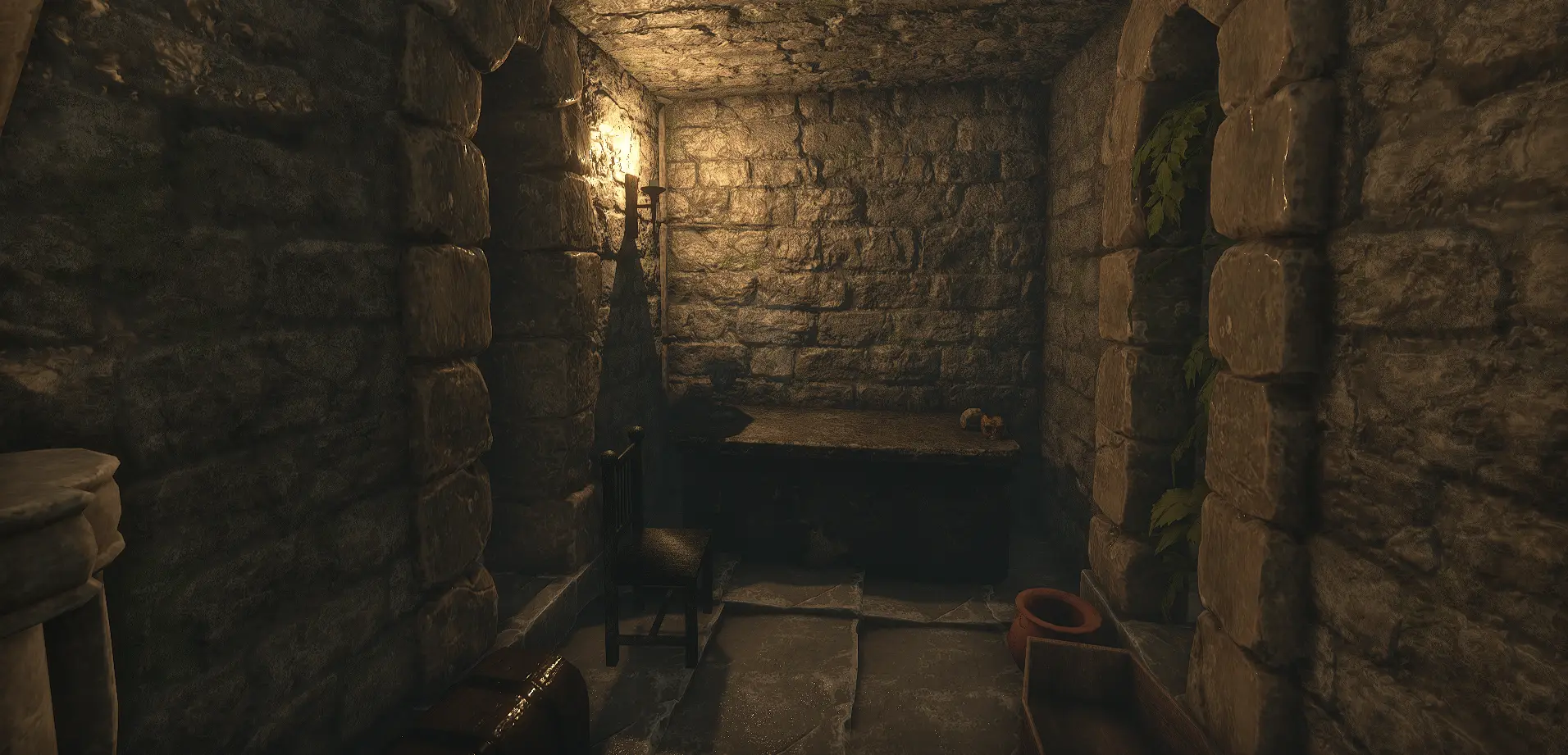 A torchlit stone cell in Grimblade, with a wooden chair and table beneath a burning wall sconce